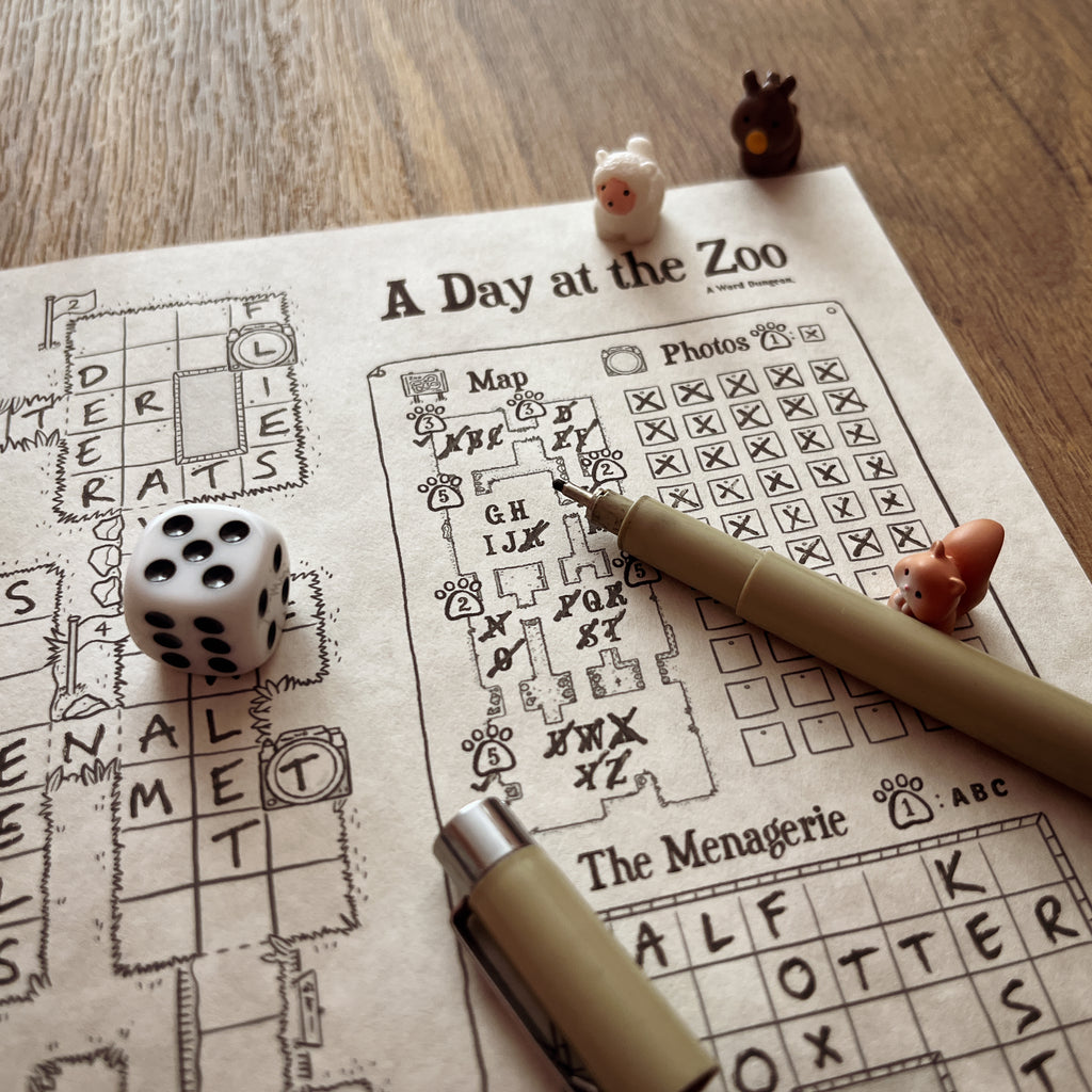 A Day at the Zoo game in progress with a die, a pen and animal figures