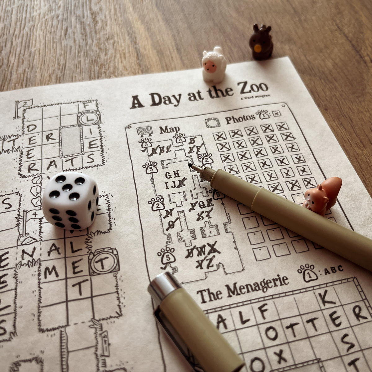 A Day at the Zoo game in progress with a die, a pen and animal figures